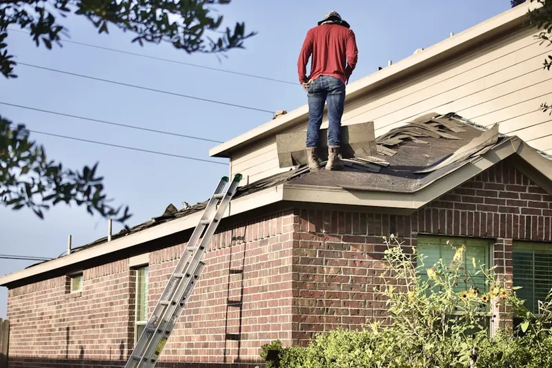 Professional roofer working on a residential roof in Mill Creek